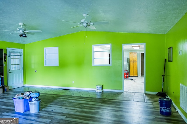 83 Manning Lake Rd SW, Rome, GA 30165 - unfurnished living room featuring a ceiling fan, wood finished floors, lofted ceiling, a textured ceiling, and healthy amount of natural light