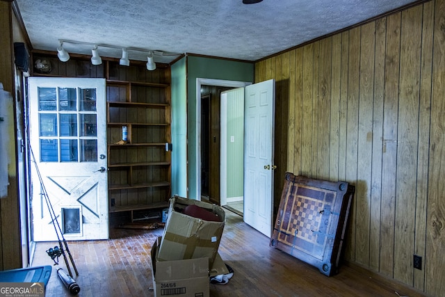 83 Manning Lake Rd SW, Rome, GA 30165 - sitting room featuring wood walls, track lighting, wood finished floors, and crown molding