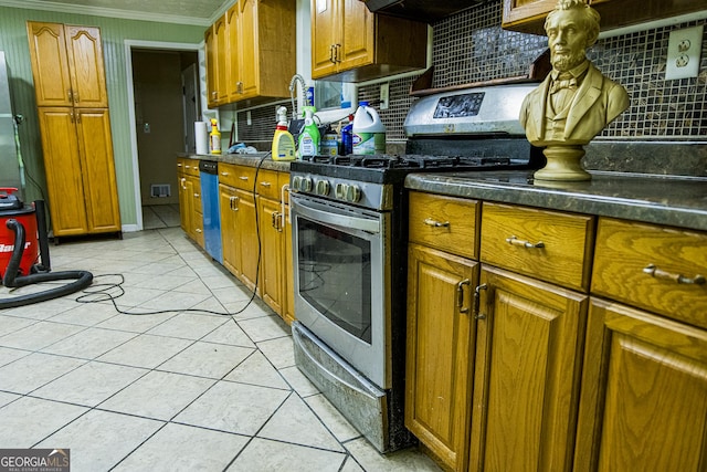 83 Manning Lake Rd SW, Rome, GA 30165 - kitchen featuring stainless steel gas range, decorative backsplash, brown cabinetry, crown molding, and dark countertops