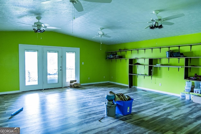 83 Manning Lake Rd SW, Rome, GA 30165 - unfurnished living room with wood finished floors, vaulted ceiling, a ceiling fan, a textured ceiling, and french doors