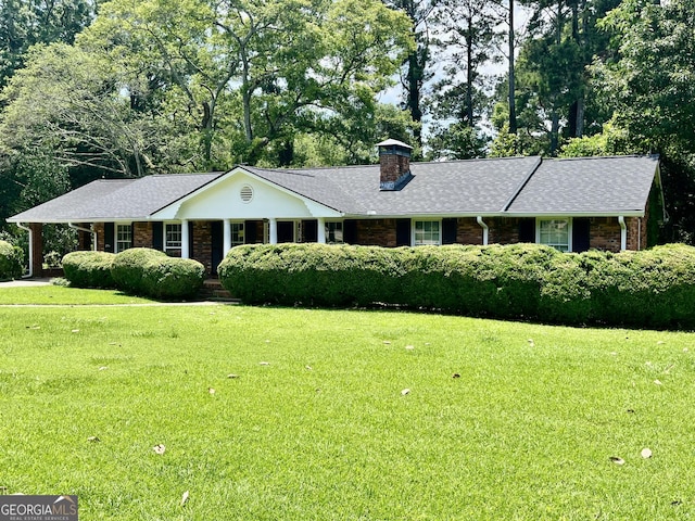 201 Glen Iris Dr, Monroe, GA 30655 - single story home featuring brick siding, a front yard, a chimney, roof with shingles, and view of wooded area