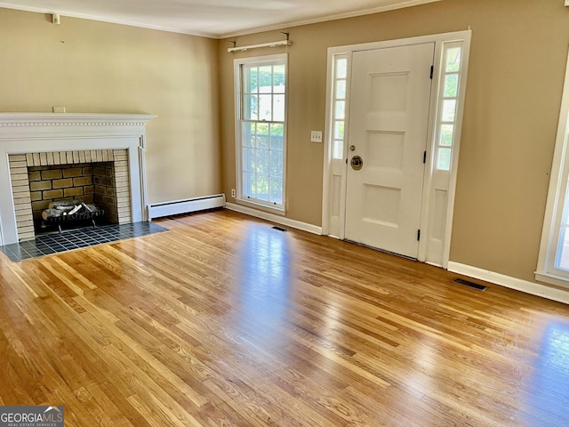 201 Glen Iris Dr, Monroe, GA 30655 - unfurnished living room with a baseboard radiator, wood finished floors, crown molding, and a fireplace