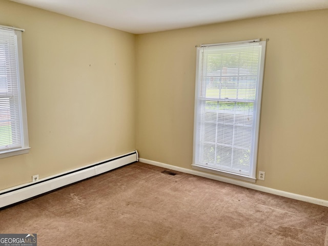 201 Glen Iris Dr, Monroe, GA 30655 - carpeted spare room with a baseboard heating unit and plenty of natural light