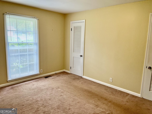 201 Glen Iris Dr, Monroe, GA 30655 - unfurnished bedroom with carpet and baseboards
