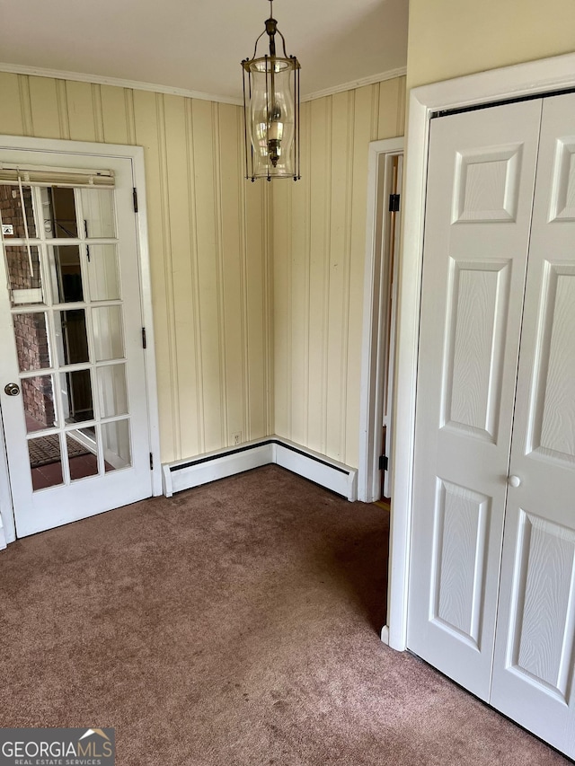 201 Glen Iris Dr, Monroe, GA 30655 - unfurnished dining area with carpet flooring, crown molding, and a chandelier