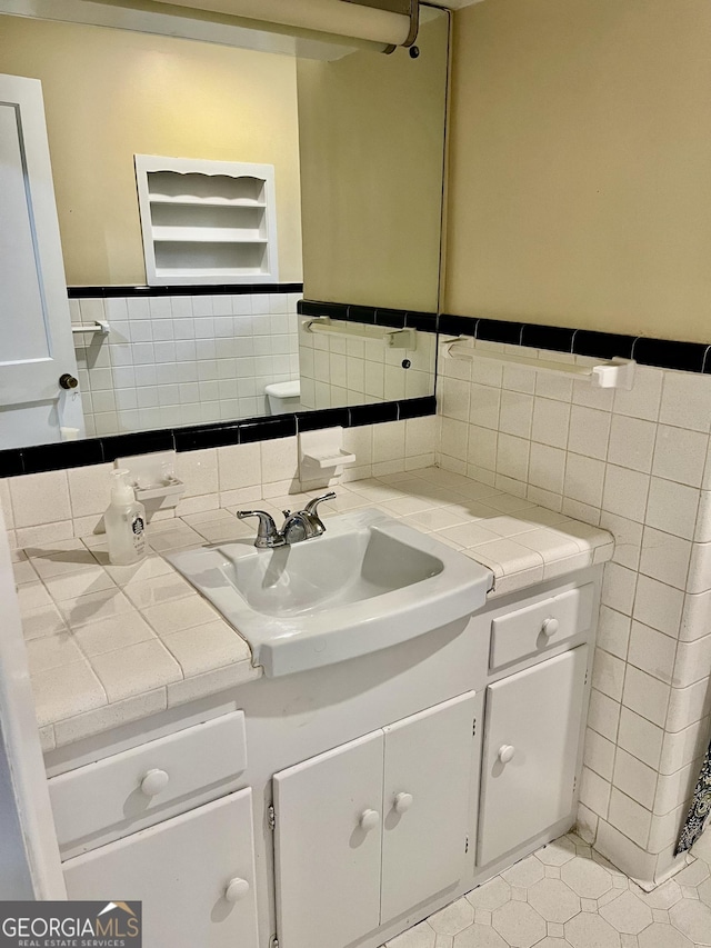 201 Glen Iris Dr, Monroe, GA 30655 - bathroom featuring tile walls, vanity, a wainscoted wall, and tile patterned flooring
