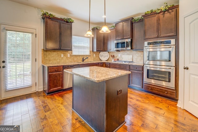 312 Relative Trl, Mcdonough, GA 30253 - kitchen with stainless steel appliances, light stone countertops, hardwood / wood-style flooring, and tasteful backsplash