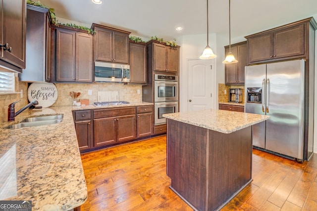 312 Relative Trl, Mcdonough, GA 30253 - kitchen featuring stainless steel appliances, light wood-style flooring, light stone counters, a kitchen island, and recessed lighting
