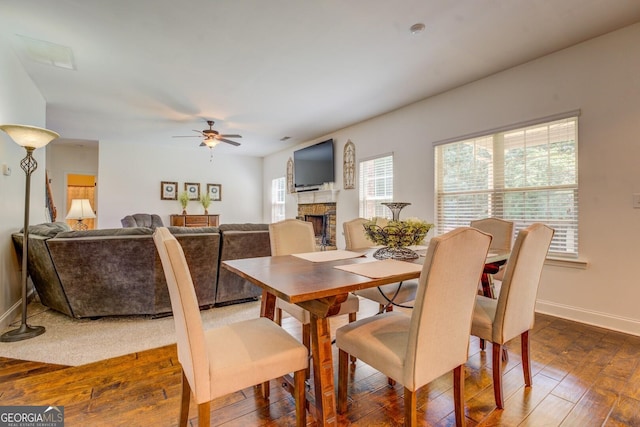 312 Relative Trl, Mcdonough, GA 30253 - dining space with ceiling fan, dark wood-type flooring, and a fireplace