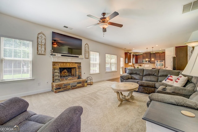 312 Relative Trl, Mcdonough, GA 30253 - living area featuring a ceiling fan, a stone fireplace, and carpet