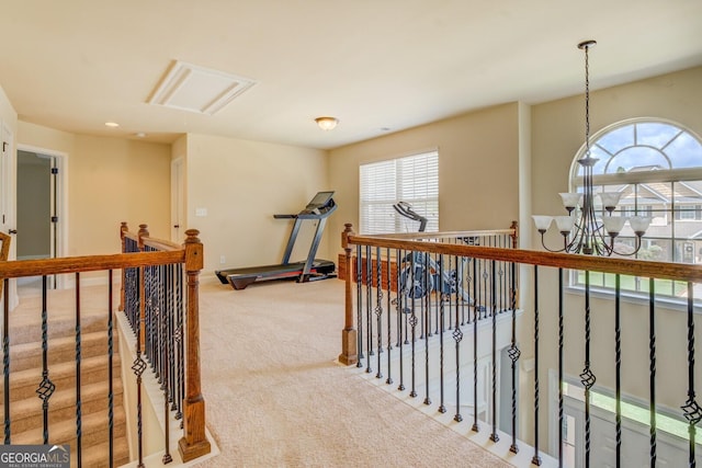 312 Relative Trl, Mcdonough, GA 30253 - hall with carpet floors, an upstairs landing, attic access, and a chandelier
