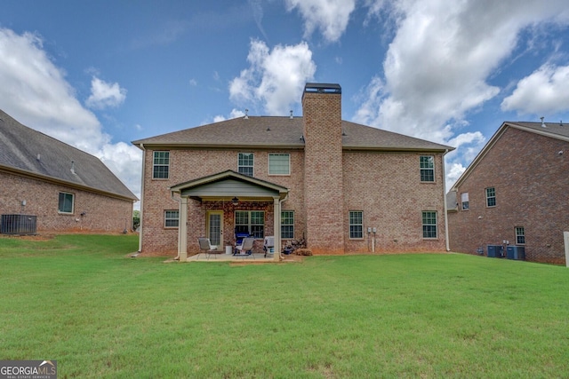 312 Relative Trl, Mcdonough, GA 30253 - rear view of house featuring ceiling fan, brick siding, a patio area, and a lawn
