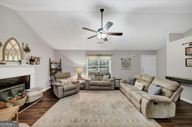 1050 Birdseye Vw, Locust Grove, GA 30248 - living room featuring a ceiling fan, wood finished floors, vaulted ceiling, and a glass covered fireplace