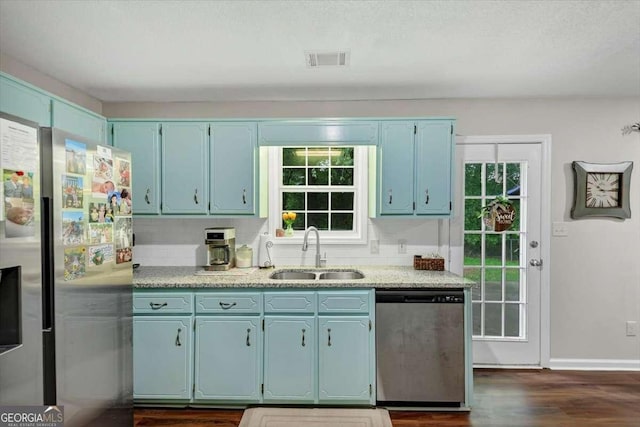 1050 Birdseye Vw, Locust Grove, GA 30248 - kitchen featuring stainless steel appliances, blue cabinets, light countertops, and plenty of natural light