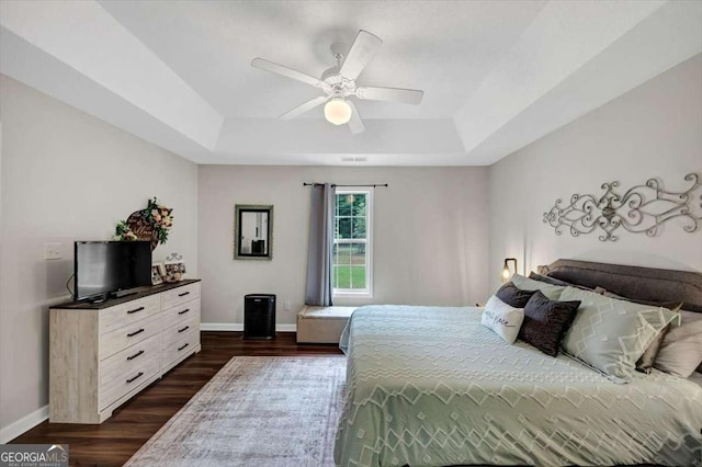 1050 Birdseye Vw, Locust Grove, GA 30248 - bedroom featuring a raised ceiling, dark wood-style floors, and ceiling fan
