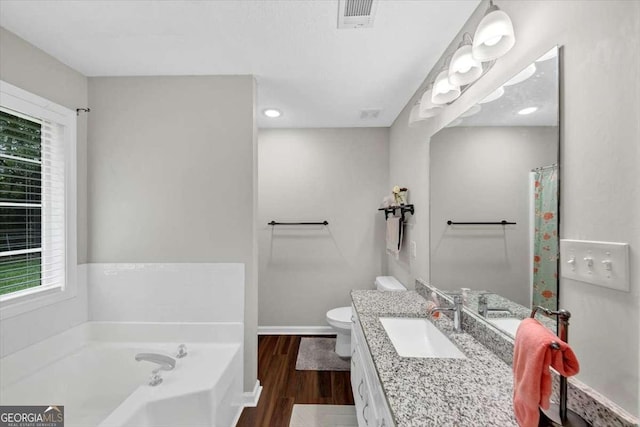 1050 Birdseye Vw, Locust Grove, GA 30248 - bathroom with vanity, a bath, wood finished floors, and recessed lighting