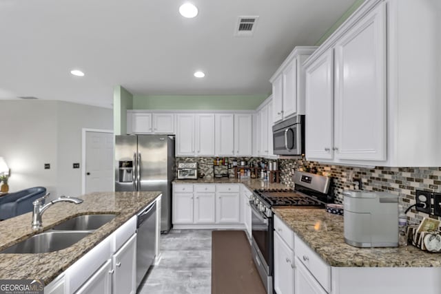 226 Creek View Ln, Acworth, GA 30102 - kitchen with stainless steel appliances, white cabinetry, stone counters, and recessed lighting