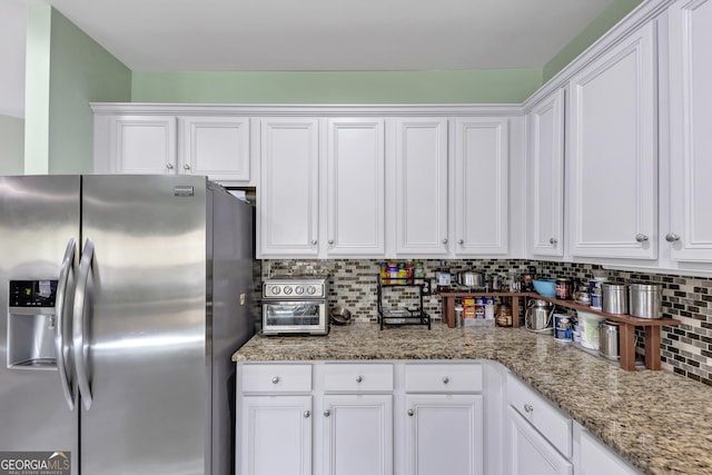 226 Creek View Ln, Acworth, GA 30102 - kitchen featuring stainless steel fridge with ice dispenser, white cabinets, tasteful backsplash, and light stone counters