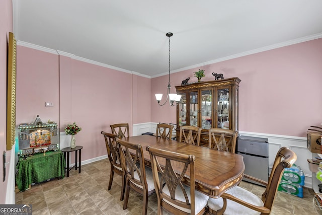226 Creek View Ln, Acworth, GA 30102 - dining area featuring a decorative wall, crown molding, stone finish flooring, a chandelier, and wainscoting