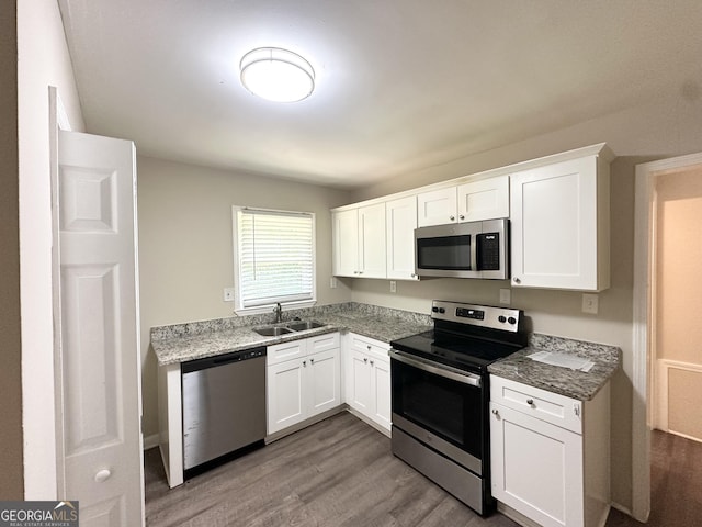 2015 Boulderview Dr SE, Atlanta, GA 30316 - kitchen with stainless steel appliances, dark wood-type flooring, and white cabinets