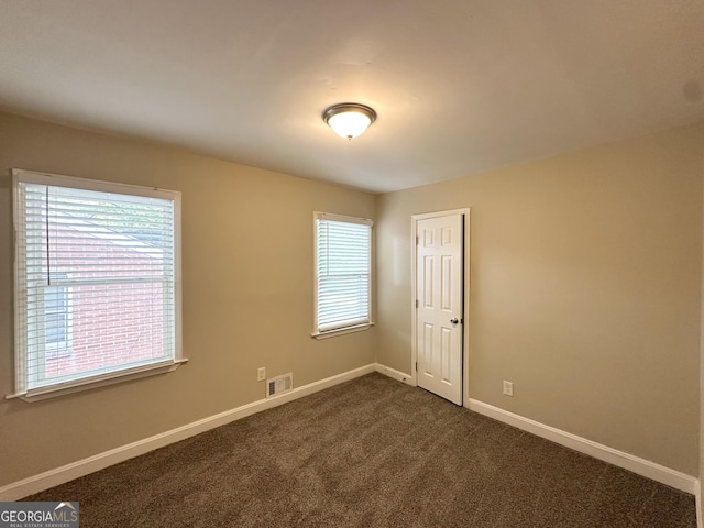 2015 Boulderview Dr SE, Atlanta, GA 30316 - unfurnished room with baseboards and dark carpet