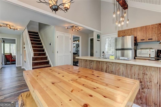 125 Wolfscratch, Big Canoe, GA 30143 - dining space featuring a chandelier, stairs, high vaulted ceiling, and dark wood-type flooring