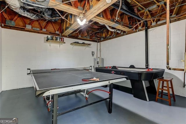 125 Wolfscratch, Big Canoe, GA 30143 - playroom featuring finished concrete floors, water heater, and concrete block wall