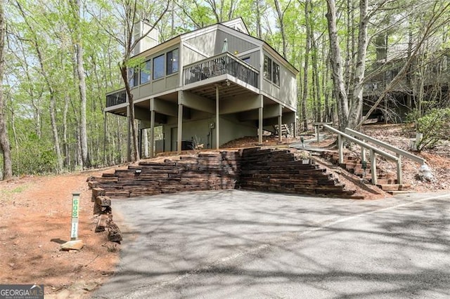 125 Wolfscratch, Big Canoe, GA 30143 - view of front facade featuring a wooden deck and stairs