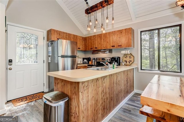 125 Wolfscratch, Big Canoe, GA 30143 - kitchen with appliances with stainless steel finishes, a wooden ceiling with exposed beams, brown cabinetry, light countertops, and a peninsula