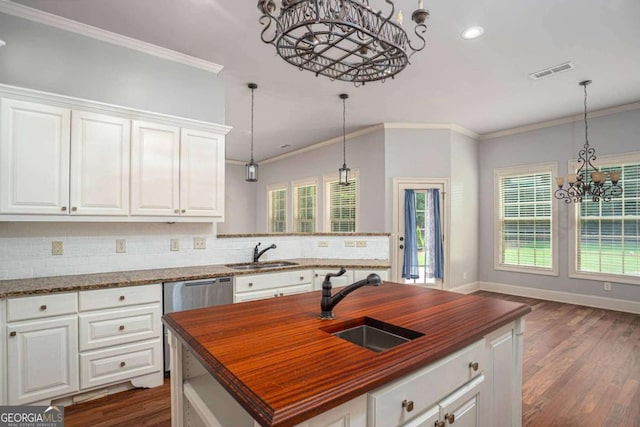 1811 Traditions Way, Jefferson, GA 30549 - kitchen featuring a chandelier, butcher block countertops, backsplash, an island with sink, and dark wood-style floors