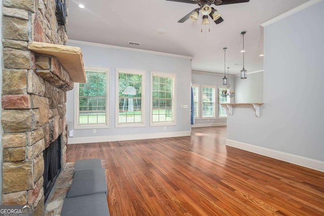 1811 Traditions Way, Jefferson, GA 30549 - unfurnished living room with a ceiling fan, wood finished floors, crown molding, and a fireplace