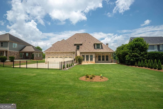1811 Traditions Way, Jefferson, GA 30549 - rear view of house featuring a fenced backyard, an attached garage, brick siding, and a chimney