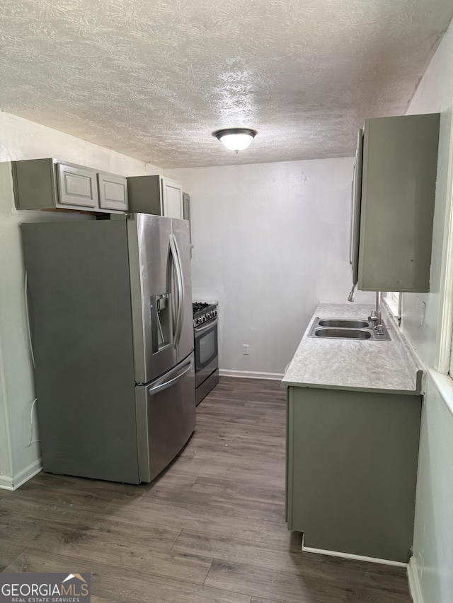2095 Mulkey Rd SW, Marietta, GA 30008 - kitchen with stainless steel appliances, a textured ceiling, light countertops, and dark wood-style floors