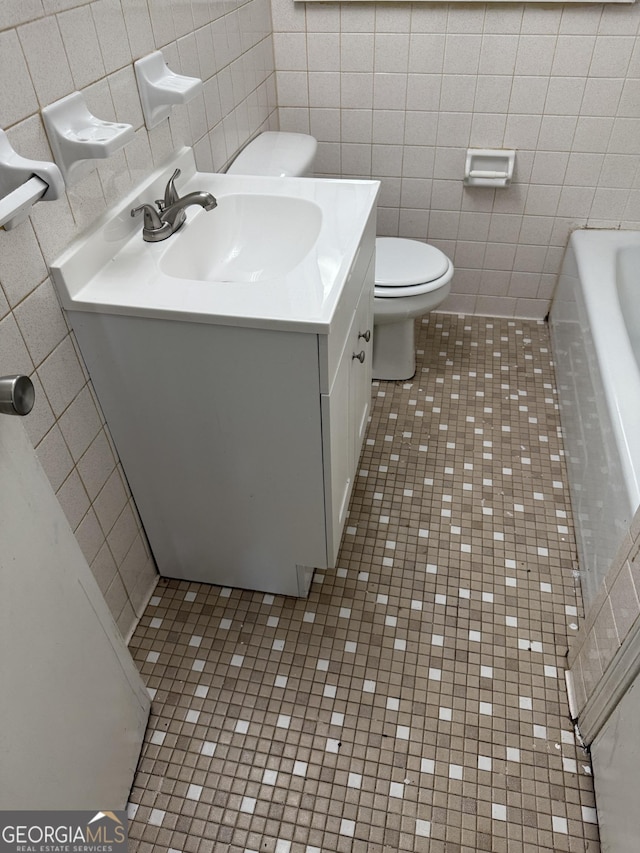 2095 Mulkey Rd SW, Marietta, GA 30008 - bathroom with tile walls, tile patterned flooring, vanity, and a tub