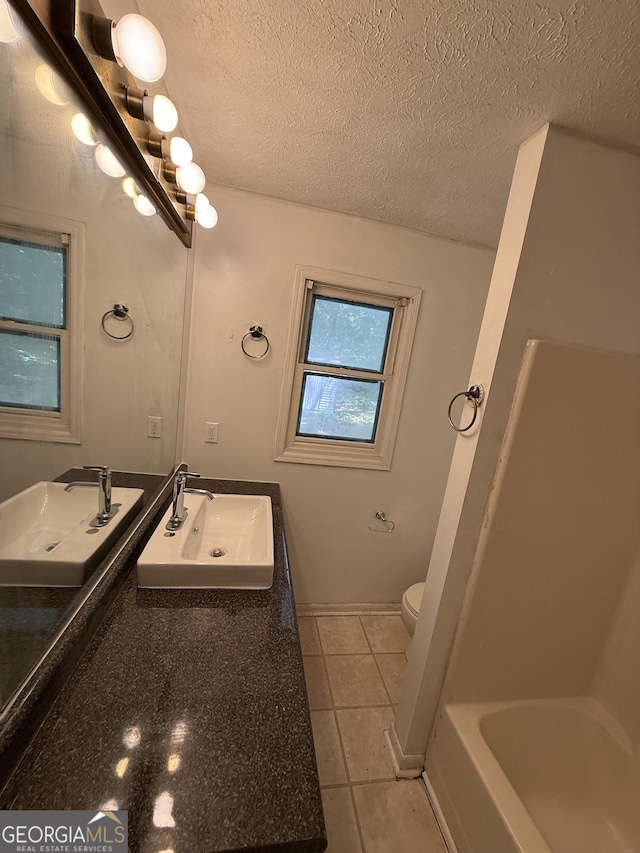 2095 Mulkey Rd SW, Marietta, GA 30008 - bathroom with vanity, a textured ceiling, and tile patterned floors