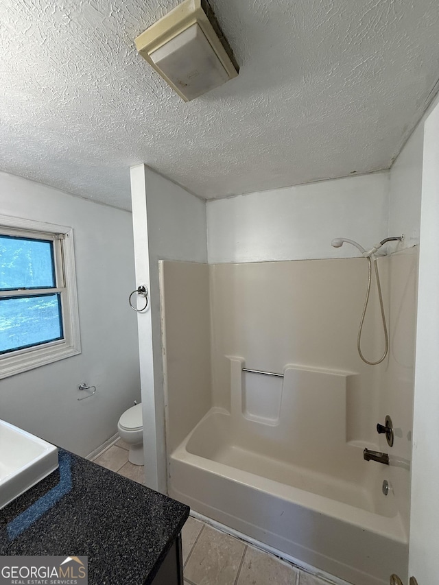 2095 Mulkey Rd SW, Marietta, GA 30008 - bathroom featuring tile patterned flooring, vanity, a textured ceiling, and  shower combination