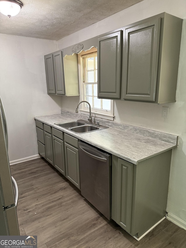 2095 Mulkey Rd SW, Marietta, GA 30008 - kitchen with stainless steel dishwasher, a textured ceiling, dark wood-style floors, gray cabinets, and light countertops