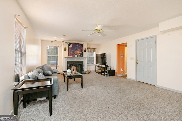 3251 Hunters Crossing Pt, Lithonia, GA 30038 - carpeted living room featuring a ceiling fan and a fireplace