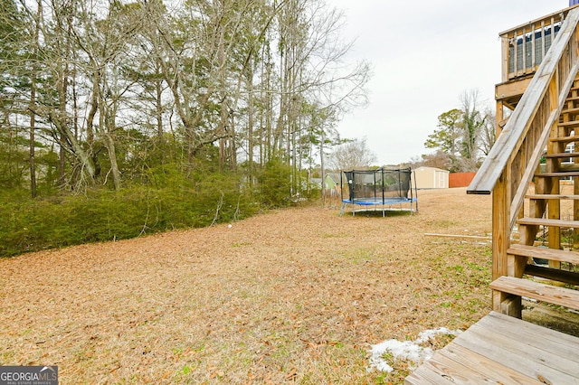 3251 Hunters Crossing Pt, Lithonia, GA 30038 - view of yard featuring stairs, a shed, a trampoline, and a wooden deck