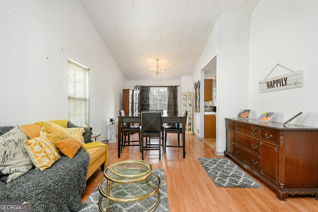 3251 Hunters Crossing Pt, Lithonia, GA 30038 - living room with a chandelier and light wood-style floors