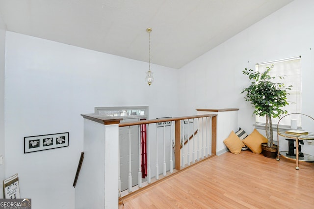 3251 Hunters Crossing Pt, Lithonia, GA 30038 - hallway featuring an upstairs landing, wood finished floors, and vaulted ceiling