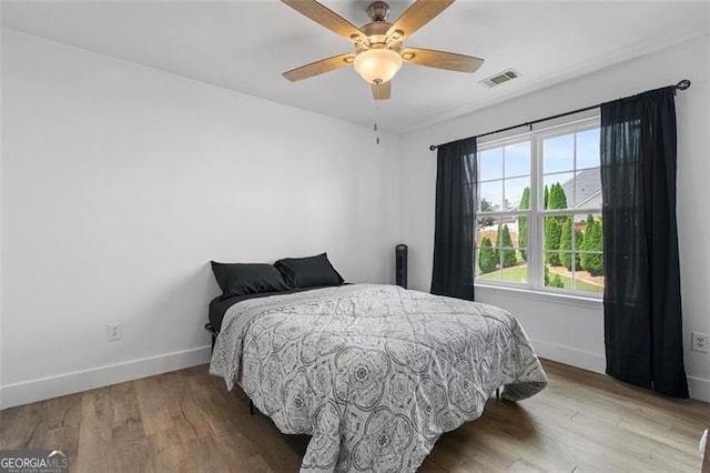 1657 Bradmere Ln, Lithia Springs, GA 30122 - bedroom with wood finished floors and ceiling fan