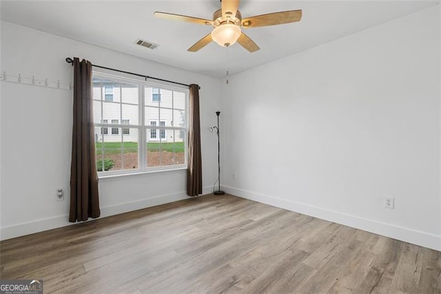 1657 Bradmere Ln, Lithia Springs, GA 30122 - spare room featuring wood finished floors and ceiling fan