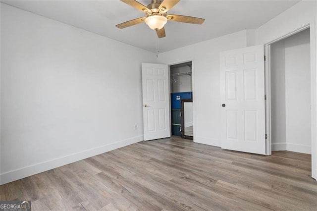 1657 Bradmere Ln, Lithia Springs, GA 30122 - unfurnished bedroom with wood finished floors and a ceiling fan