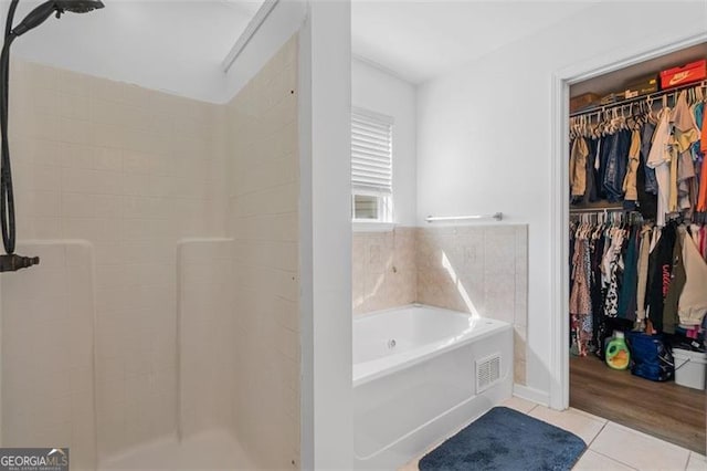 1657 Bradmere Ln, Lithia Springs, GA 30122 - full bath with tile patterned floors, a garden tub, a walk in closet, and a shower stall