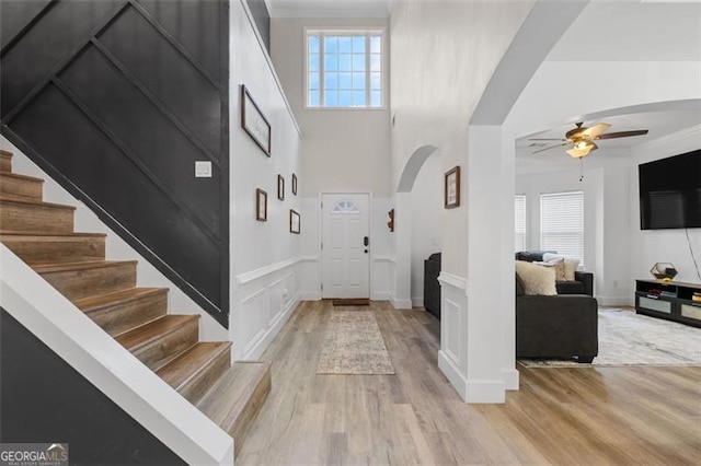 1657 Bradmere Ln, Lithia Springs, GA 30122 - foyer entrance with arched walkways, ceiling fan, healthy amount of natural light, stairs, and a towering ceiling