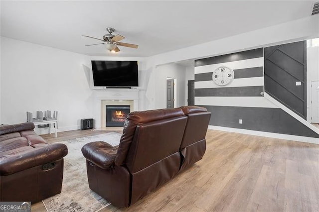 1657 Bradmere Ln, Lithia Springs, GA 30122 - living room with ceiling fan, a lit fireplace, and wood finished floors
