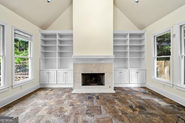 3450 Merganser Ln, Alpharetta, GA 30022 - unfurnished living room featuring vaulted ceiling, built in shelves, stone finish floors, and a fireplace