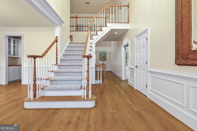 3450 Merganser Ln, Alpharetta, GA 30022 - stairs with wood finished floors, wainscoting, and crown molding
