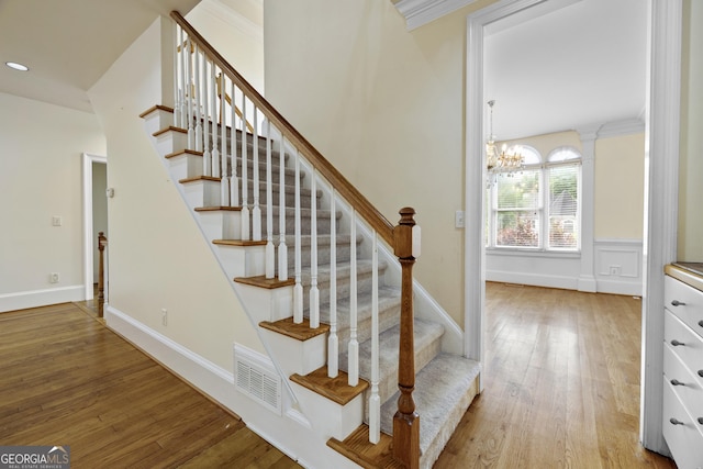 3450 Merganser Ln, Alpharetta, GA 30022 - staircase with wood finished floors, a chandelier, crown molding, and recessed lighting